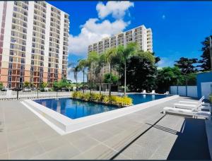 a swimming pool in front of two tall buildings at JIYA Studio and Breakfast in Cebu City
