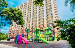 a playground in front of a large building at JIYA Studio and Breakfast in Cebu City