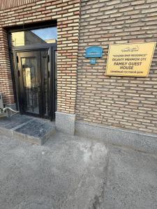 a door to a building with a sign on it at Golden Emir Residence in Bukhara