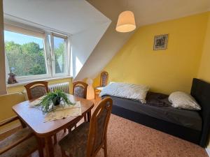 a small room with a bed and a table and a window at Modern Stay Apartments in Kassel
