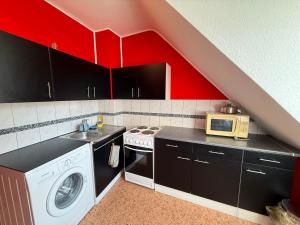 a kitchen with a sink and a washing machine at Modern Stay Apartments in Kassel