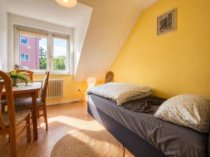 a bedroom with a bed and a table and a window at Modern Stay Apartments in Kassel