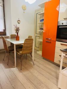 a kitchen with a table and chairs and an orange cabinet at Vicolo in Fiore House in Orvieto +25 photos