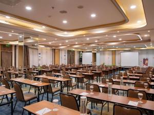 an empty banquet hall with tables and chairs at Ibis Bandung Pasteur in Bandung