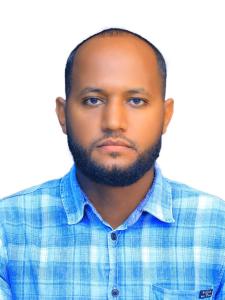 a man wearing a blue shirt with a beard at Blue bird in Addis Ababa