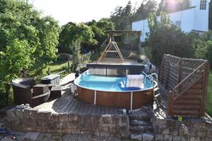 a hot tub in a backyard with a fence at Ferienwohnung Carlo in Bindlach