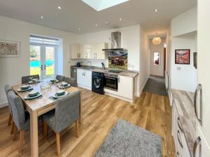 a kitchen and dining room with a table and chairs at North Lodge in Forgandenny