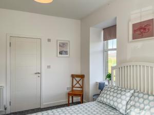 a bedroom with a bed and a sliding door at North Lodge in Forgandenny +6 photos
