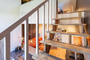 a staircase in a house with a living room at Thús yn Hantum Vakantiehuisje met hottub in Friesland in Hantum