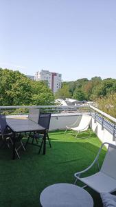a patio with a table and chairs on a balcony at Royal VIP in Kołobrzeg