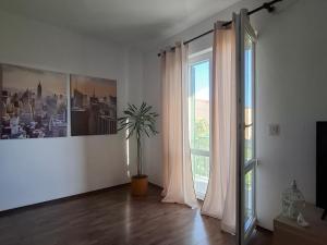 a living room with a window and a potted plant at Apartment Računica in Vodice