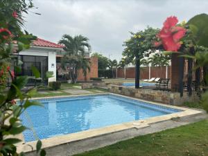 a swimming pool in the yard of a house at Sweet Home in San Guillermo +12 photos