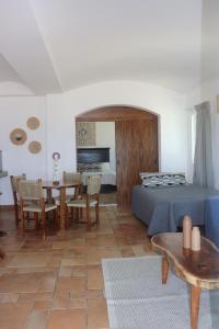 a bedroom with a bed and a table and chairs at Beachfront Condominium in Tulum in Tulum