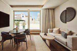 a living room with a couch and a table at Nobu Hotel Madrid in Madrid