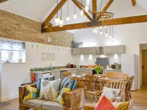 a kitchen and dining room with a table and chairs at 'Ow Do - Uk11446 in Skipsea