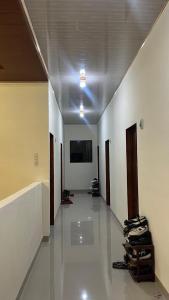 a hallway with white walls and a ceiling at Kos Pramuka in Sunggal
