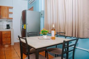 a kitchen with a table with a bottle of wine at #5 Mini Suite, Cerca de Todo, 2-3 people - AC in Puerto Ayora