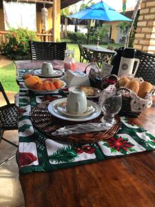 a table with a christmas table cloth with food on it at Pouso do Kite Pousada Flecheiras in Flecheiras
