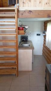 a kitchen with wooden stairs and a stove top oven at Finca La Vilina - Tiny House in San Rafael
