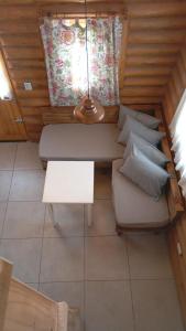 a room with a couch and a table and a window at Finca La Vilina - Tiny House in San Rafael