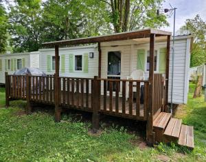 a tiny house with a porch and a deck at Schatzele in Boofzheim +16 photos