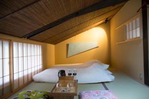 Säng eller sängar i ett rum på Ryokan Mugen (Adult Only)