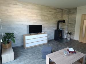a living room with a flat screen tv on a wall at Apartmán Velký Luh in Velký Luh