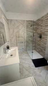 a white bathroom with a sink and a shower at B&B Mavi in Como