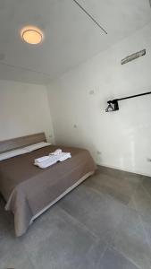a bedroom with a bed in a white room at B&B Mavi in Como