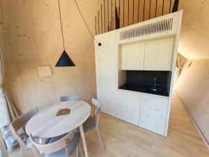 a small kitchen and dining room with a table and chairs at Glamp Camp Danica in Bohinj