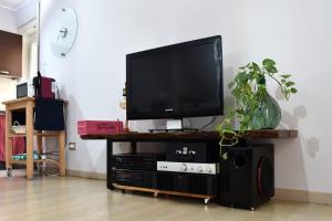 a flat screen tv sitting on top of a entertainment center at B&B Casale in Avellino