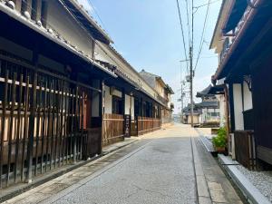 an empty street in an asian town with buildings at Sanada Maru - Entire traditional Japanese house in Kaizuka