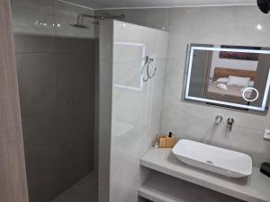 a bathroom with a shower and a sink and a mirror at Villa Elia in Kástron +31 photos
