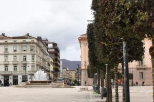 a city street with buildings and a fountain at B&B Casale in Avellino
