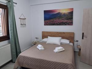 a bedroom with a bed with two towels on it at Villa Elia in Kástron