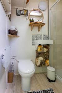 a bathroom with a toilet and a shower at Tiny House in Kampen +9 photos