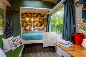 a bedroom in a tiny house with a bed in it at Tiny House in Kampen