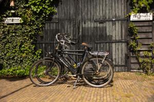a black bike parked next to a wooden fence at Tiny House in Kampen