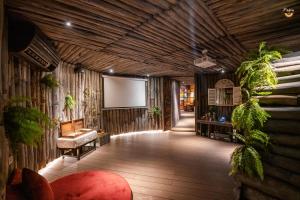 a living room with a couch and a screen at P'apiu Resort in Ha Giang