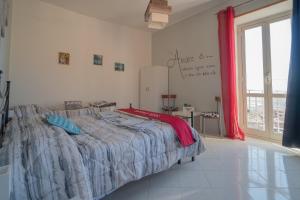 a bedroom with a bed and a large window at Nido d'amore in Anagni