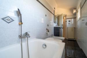 a white bathroom with a tub and a toilet at Nido d'amore in Anagni +28 photos