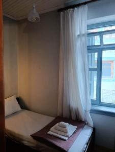a bed with towels on it next to a window at Coralia Nest Studio in Glossa