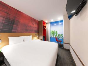 a hotel room with a large bed and a sign at ibis Styles Ambassador Seoul Myeong-dong in Seoul