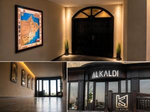 a building with a black door and a sign at AL KALDi in Salalah