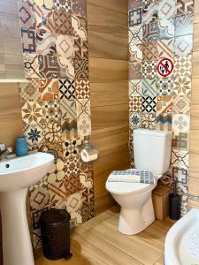 a bathroom with a toilet and a sink at Soso studios & apartments in Stavros +97 photos