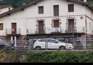 a white car parked in front of a white building at Ostatu ikaztegieta in Aldaba-chiqui