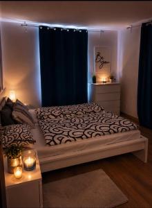 a bedroom with a large bed with blue curtains and lights at Casa NICOLE in Malá Morávka +21 photos
