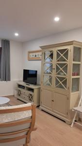 a living room with a large cabinet and a tv at Piso Covian in Ribadesella