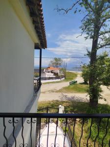 a balcony of a house with a view of the beach at Apostolis Seaside Living in Olympiada