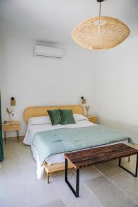 a bedroom with a bed and a wooden table at BeB Villa Pacifica in Peschici